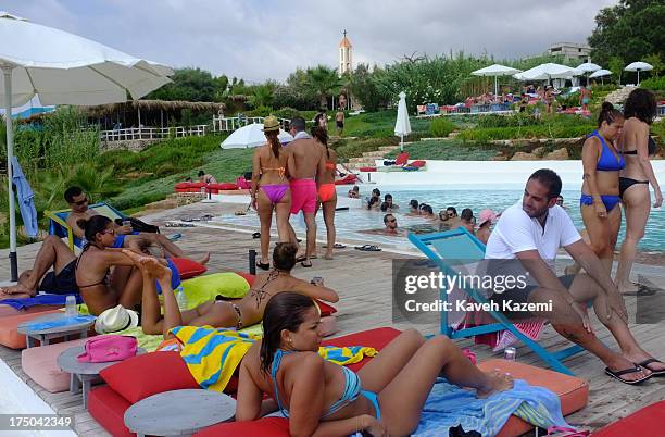 Lebanese enjoy a day at Lazy B beach resort in a secluded surrounding 20 minutes outside the capital on July 21, 2013 in Beirut, Lebanon. Despite the...