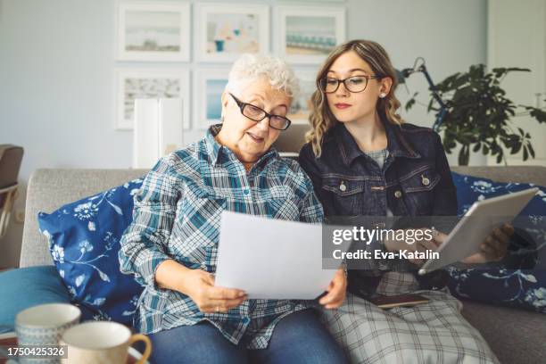 senior woman at home - grandma invoice stock pictures, royalty-free photos & images