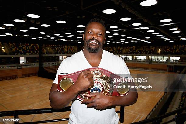 Dereck Chisora poses with his WBO International Heavyweight Championship belt prior to a press conference organised by boxing promoter Frank Warren...
