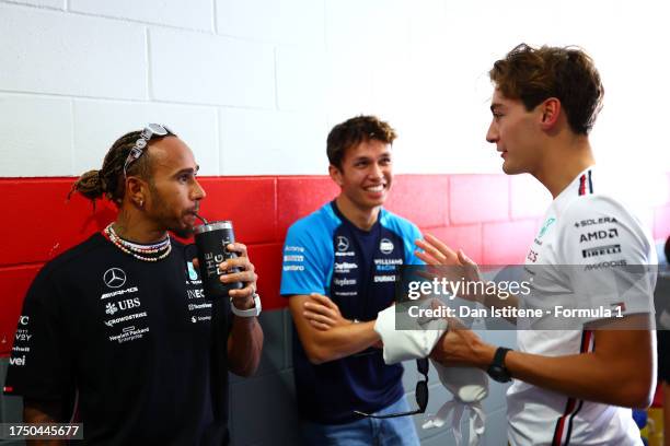 Lewis Hamilton of Great Britain and Mercedes speaks to George Russell of Great Britain and Mercedes and Alexander Albon of Thailand and Williams in...
