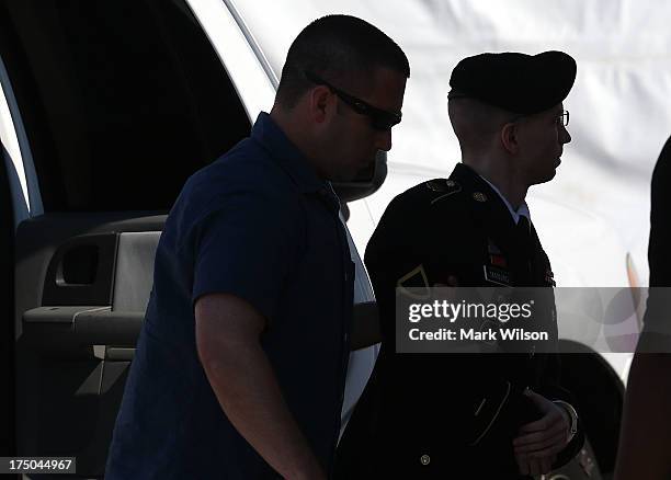 Army Private First Class Bradley Manning is escorted by military police as arrives to hear the verdict in his military trial July 30, 2013 at Fort...