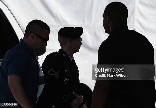 Army Private First Class Bradley Manning is escorted by military police as arrives to hear the verdict in his military trial July 30, 2013 at Fort...