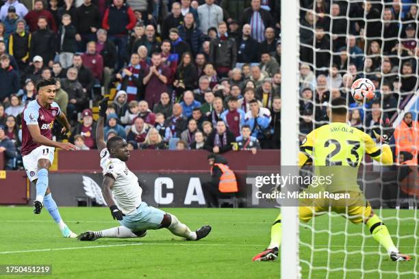 Ollie Watkins of Aston Villa scores the team's third goal past Alphonse Areola of West Ham United during the Premier League match between Aston Villa...