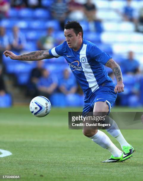 Lee Tomlin of Peterborough United runs with the ball during the pre season friendly match between Peterborough United and Hull City at London Road...