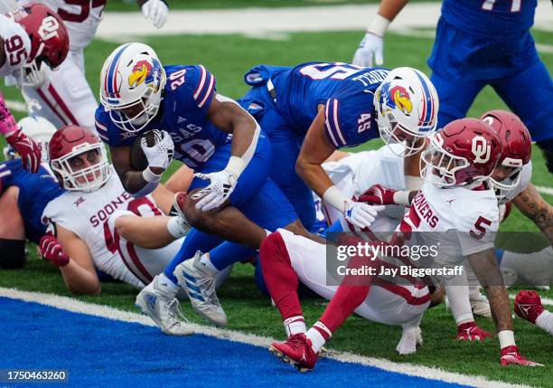 Daniel Hishaw Jr. #20 of the Kansas Jayhawks runs for a touchdown against the Oklahoma Sooners during the second half at David Booth Kansas Memorial...