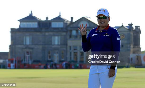 Inbee Park of South Korea standing on the Swilken Bridge as she holds up four fingers to signal her attempt to complete the Grand Slam of all four...