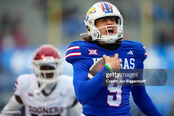 Jason Bean of the Kansas Jayhawks runs past Kendel Dolby of the Oklahoma Sooners for a touchdown during the second half at David Booth Kansas...