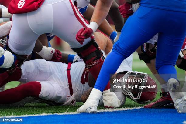 Dillon Gabriel of the Oklahoma Sooners is stopped short of the goal line during the second half against the Kansas Jayhawks at David Booth Kansas...
