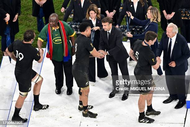French President Emmanuel Macron shakes New Zealand's number eight Ardie Savea's hand as President of South Africa Cyril Ramaphosa shakes New...