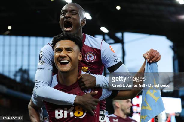Ollie Watkins of Aston Villa celebrates with teammate Moussa Diaby after scoring his side's third goal during the Premier League match between Aston...