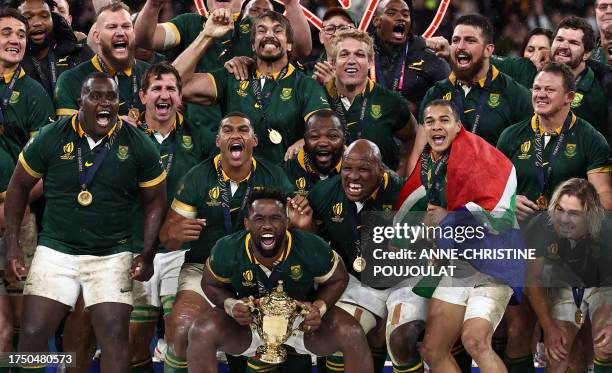 South Africa's flanker and captain Siya Kolisi prepares to lift the Webb Ellis Cup on the podium after South Africa won the France 2023 Rugby World...