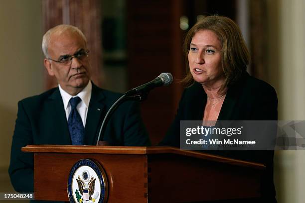 Israeli Justice Minister Tzipi Livni delivers remarks on the Middle East Peace Process Talks, as Palestinian chief negotiator Saeb Erekat listens at...