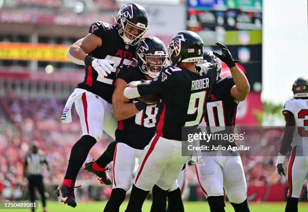 The Atlanta Falcons celebrate after Desmond Ridder of the Atlanta Falcons scores a touchdown in the first quarter of the game against the Tampa Bay...