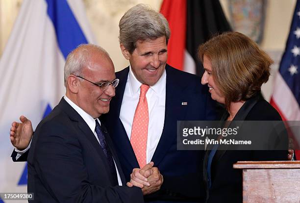 Secretary of State John Kerry watches as Israeli Justice Minister Tzipi Livni and Palestinian chief negotiator Saeb Erekat shake hands during a...