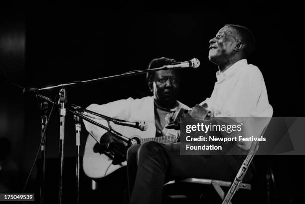 Blues greats Muddy Waters and Son House share the stage at the Newport Folk Festival in July, 1969 in Newport, Rhode Island.