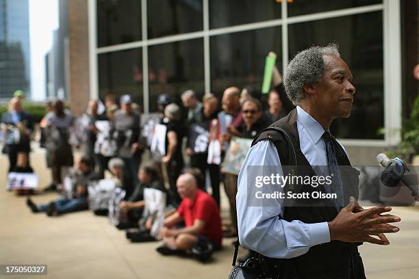 Pulitzer prize winning, former Chicago Sun-Times photographer John H. White gives an interview while behind him current and former Chicago Sun-Times...