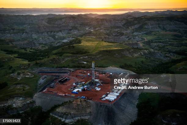An oil drilling rig is seen in an aerial view in the early morning hours of July 30, 2013 near Watford City, North Dakota. The state has seen a boom...