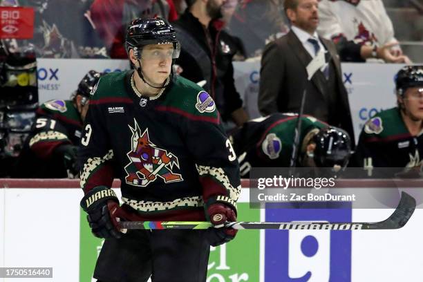 Travis Dermott of the Arizona Coyotes skates on the ice with pride tape at Mullett Arena on October 21, 2023 in Tempe, Arizona.