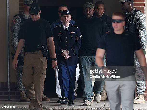 Army Private First Class Bradley Manning is escorted by military police as he leaves his military trial after he was found guilty of 20 out of 21...