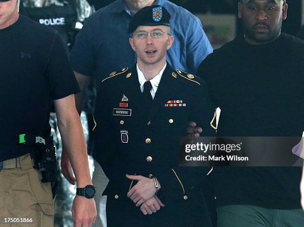 Army Private First Class Bradley Manning is escorted by military police as he leaves his military trial after he was found guilty of 20 out of 21...