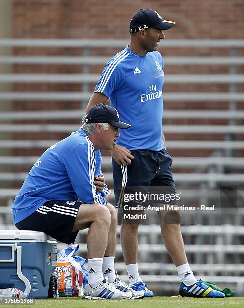 Head coach Carlo Ancelotti and assistant coach Zinedine Zidane of Real Madrid follow their players during a training session at UCLA Campus on July...