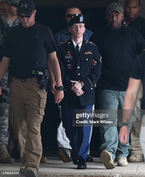 Army Private First Class Bradley Manning is escorted by military police as he leaves his military trial after he was found guilty of 20 out of 21...