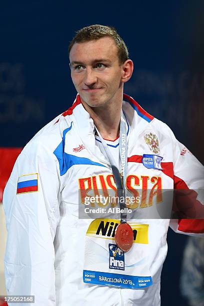 Bronze medal winner Danila Izotov of Russia celebrates on the podium after the Swimming Men's 200m Freestyle Final on day eleven of the 15th FINA...