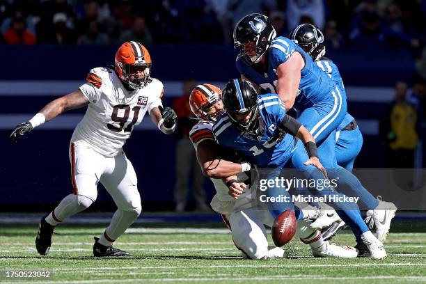 Gardner Minshew of the Indianapolis Colts fumbles the ball against Myles Garrett of the Cleveland Browns during the first quarter at Lucas Oil...