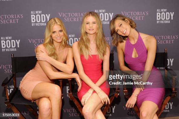 Models Erin Heatherton, Behati Prinsloo and Karlie Kloss pose during Victoria's Secret Angels meet fans at Body by Victoria at Victoria's Secret SoHo...