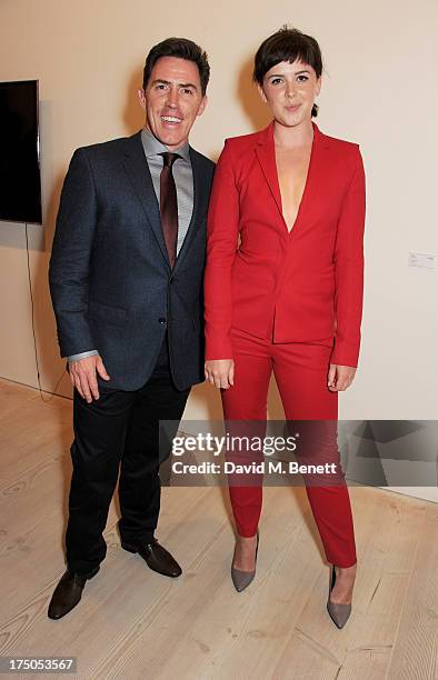 Rob Brydon and Alexandra Roach attend a private view of 'HUGO: Red Never Follows', celebrating 20 years of Hugo Boss, at the Saatchi Gallery on July...