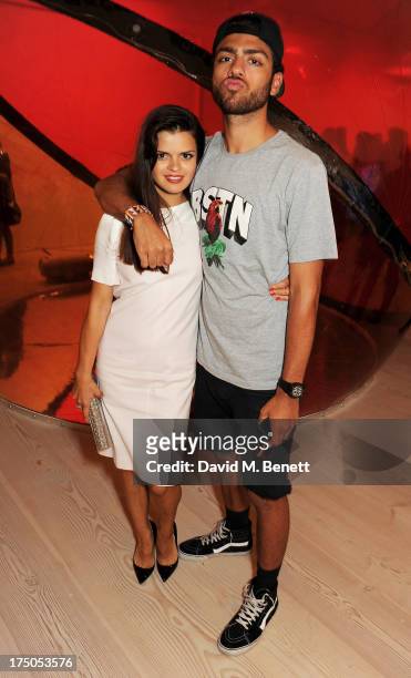 Bip Ling and Noah Becker attend a private view of 'HUGO: Red Never Follows', celebrating 20 years of Hugo Boss, at the Saatchi Gallery on July 30,...