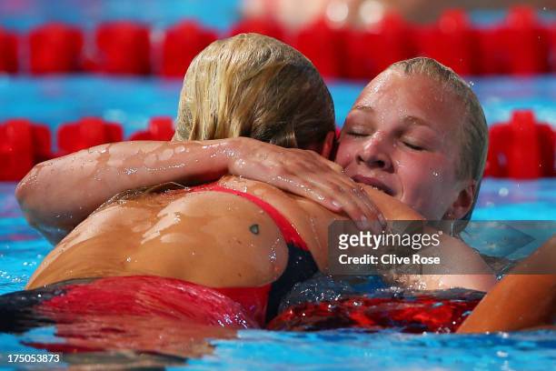 Ruta Meilutyte of Lithuania celebrates with Jessica Hardy of the USA after the Swimming Women's 100m Breastroke Final on day eleven of the 15th FINA...