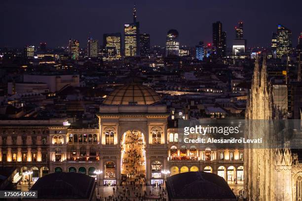 The entrance of Galleria Vittorio Emanuele with the Milan's Cathedral on the right and on the back the Skyline of the modern part of the city on...