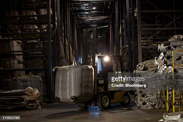 Forklift moves bags of coffee in a storage area at the Japy grain house and silo complex belonging to the Cooxupe cooperative in the Minas Gerais...