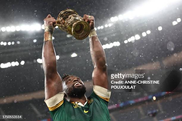 South Africa's flanker and captain Siya Kolisi lifts the Webb Ellis Cup after South Africa won the France 2023 Rugby World Cup Final match between...