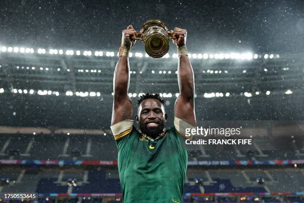 South Africa's flanker and captain Siya Kolisi lifts the Webb Ellis Cup as he celebrates winning the France 2023 Rugby World Cup final match against...