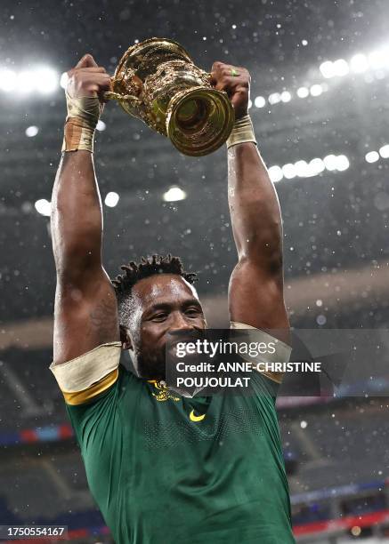 South Africa's flanker and captain Siya Kolisi lifts the Webb Ellis Cup after South Africa won the France 2023 Rugby World Cup Final match between...