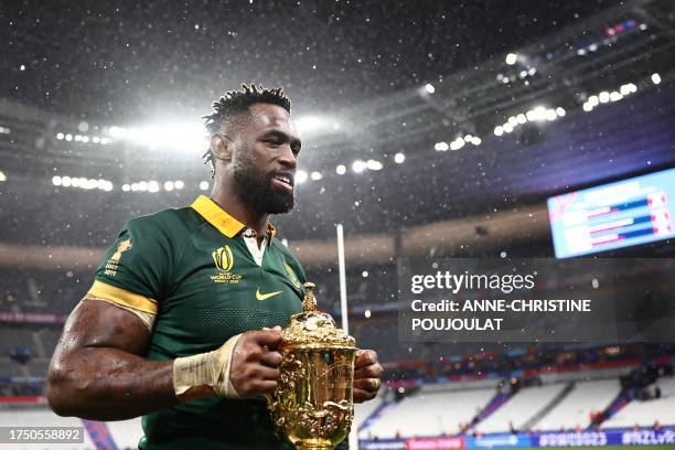 South Africa's flanker and captain Siya Kolisi holds the Webb Ellis Cup after South Africa won the France 2023 Rugby World Cup Final match between...