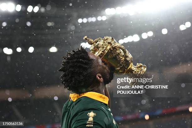 South Africa's flanker and captain Siya Kolisi kisses the Web Ellis Cup after South Africa won the France 2023 Rugby World Cup Final match between...