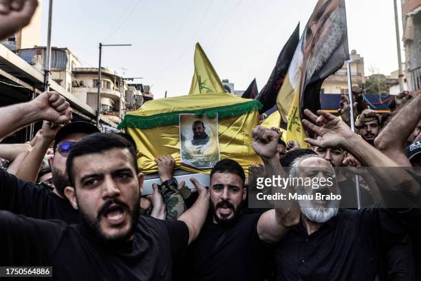 Hezbollah supporters chats slogans against Israel while carrying the coffin of a Hezbollah militant killed by IDF while clashing yesterday in...