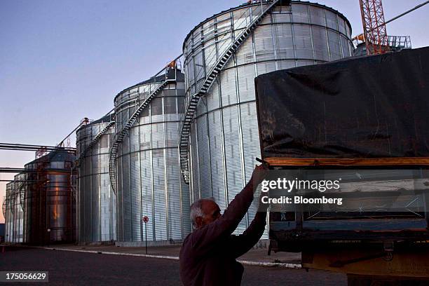 Worker makes a final check on a truck before it leaves the Japy grain house and silo complex belonging to the Cooxupe coffee cooperative in the Minas...