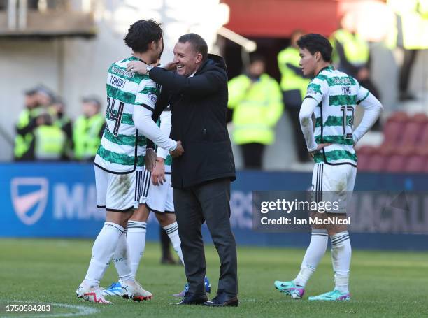 Tomoki Iwata of Celtic is seen with the manager Brendan Rodgers during the Cinch Scottish Premiership match between Heart of Midlothian and Celtic FC...