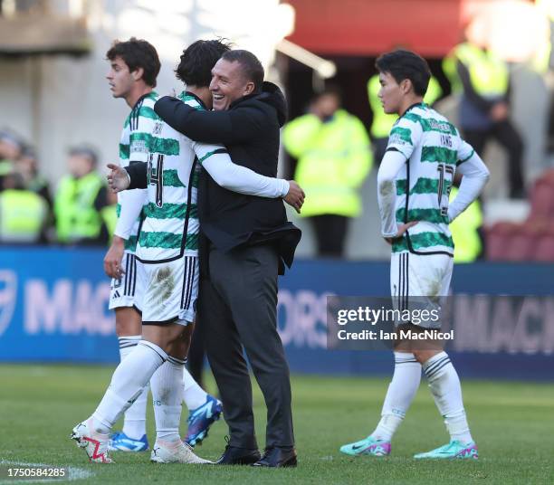 Tomoki Iwata of Celtic is seen with the manager Brendan Rodgers during the Cinch Scottish Premiership match between Heart of Midlothian and Celtic FC...