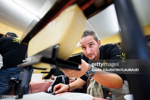 Scaper" checks a piece of cheese before scraping a raclette during the first-ever Raclette World Championships featuring local and international...