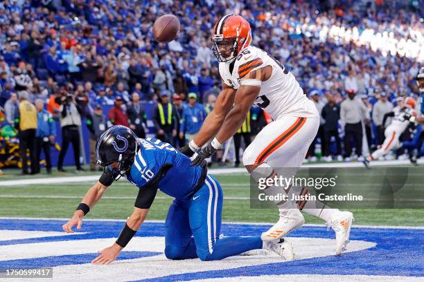 Gardner Minshew of the Indianapolis Colts fumbles the ball against Myles Garrett of the Cleveland Browns during the second quarter at Lucas Oil...