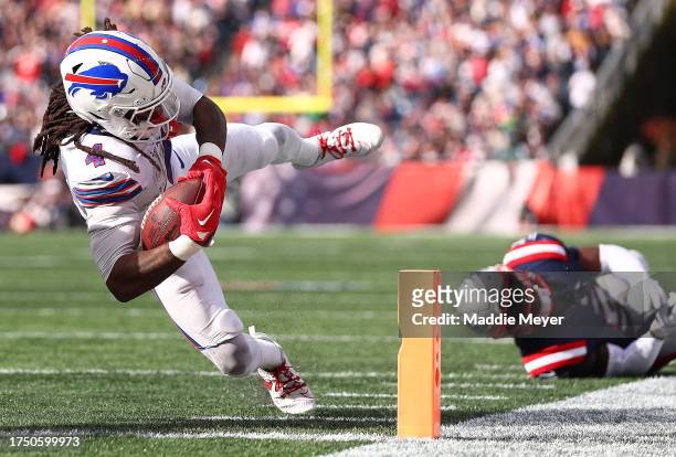 James Cook of the Buffalo Bills scores a touchdown in the third quarter of the game against the New England Patriots at Gillette Stadium on October...