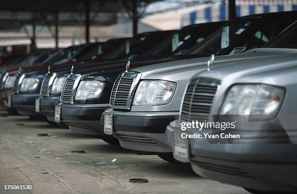 Rows of second-hand mercedes lined up for sale in Bangkok. Many people had to sell their luxury cars after Thailand's economy collapsed in July 1997..