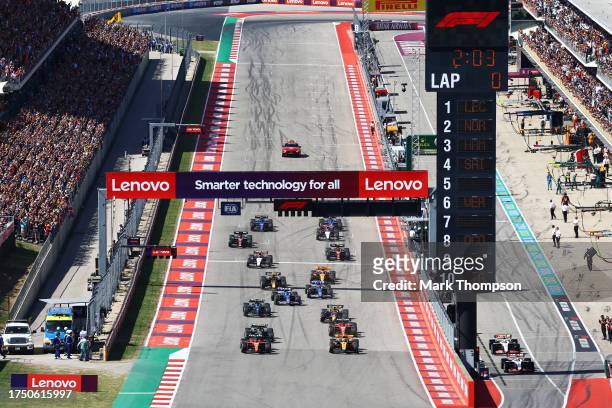 Charles Leclerc of Monaco driving the Ferrari SF-23 and Lando Norris of Great Britain driving the McLaren MCL60 Mercedes lead the field at the start...