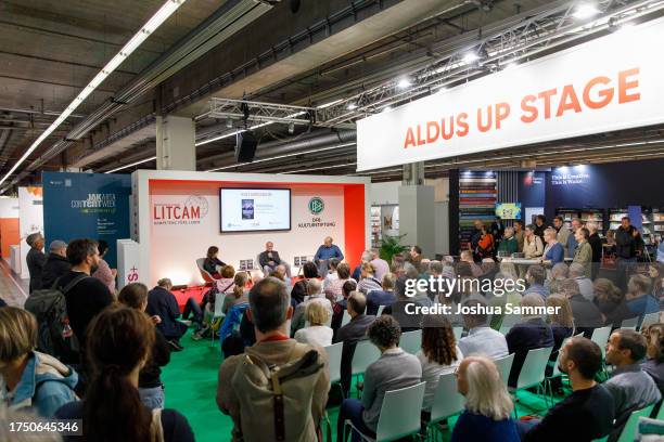 Karin Plötz, Wolfgang Overath and Sven Pistor speak on the podium at the DFB 'Kulturstadion' at Frankfurt Book Fair on October 22, 2023 in Frankfurt...