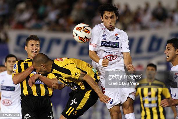 Ernesto Cristaldo of The Stongest and Angel Almiron of Nacional fight for the ball during a match between Nacional and The Stongest as part of the...